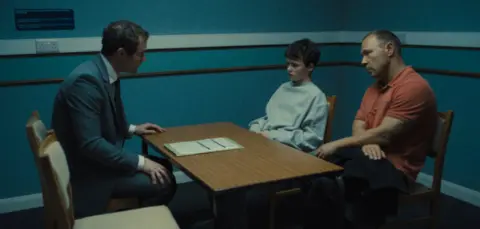 Netflix Owen Cooper being interviewed by the police in the Netflix drama alongside his dad played by Stephen Graham