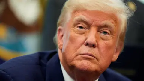 Reuters A close-up of President Donald Trump's face, bearing a serious expression