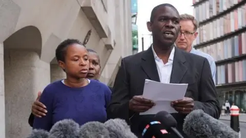 The parents of 14 year-old Daniel Anjorin, Dr Ebenezer Anjorin (centre), and his mother Grace (left), speaking outside the Old Bailey in London after the sentencing of samurai sword killer Marcus Arduini Monzo for the murder of Daniel Anjorin and a series of other violent offences committed during a samurai sword rampage in Hainault, north-east London, in April 2024. Picture date: Friday June 27, 2025