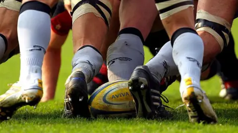 A rugby ball at the back of a scrum