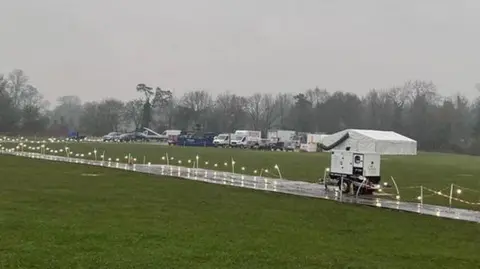 Peter Aitken A marquee and temporary pathways can be seem on the flood plain next to the River Ver near Westminster Lodge together with some production vehicles.