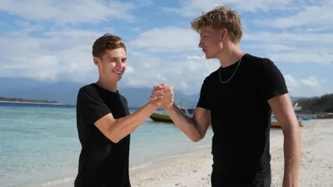 Studio Lambert Alfie and Owen are celebrating on a beach