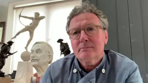 David Williams-Ellis in his studio with parts of partially completed works behind him