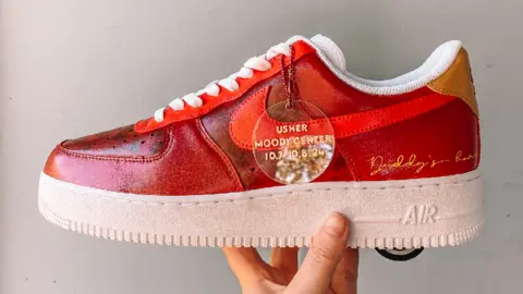 Tesni DeLuna Custom trainers that Ms DeLuna painted for Usher. They are Nike Air trainers and have been painted red with some extra personalised details including the song title Daddy's Home. 