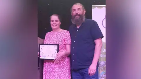 Martin Cove Owners of the mill in Middleton, Martin and Paula. He has dark, greying hair and a beard. She has swept-back dark hair.