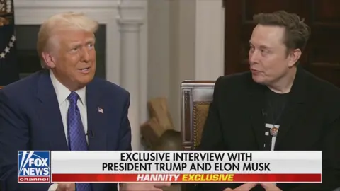 Donald Trump and Elon Musk sitting next to each other during interview