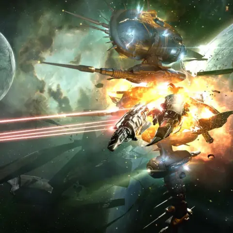 Fenris Creations A detailed space combat scene from EVE Online showing a large, spherical space station or defence platform with protruding cannons and antennae suspended in orbit near a planet. In the foreground, a sleek, armoured spacecraft is being struck and erupting in a bright orange explosion, with fragments and debris scattering outward. Multiple red laser beams streak across the scene from left to right, aimed toward the exploding ship. Surrounding the central action are several other spacecraft of varying sizes, partially silhouetted against a green nebula backdrop filled with stars and drifting clouds of gas. A curved planetary surface is visible along the left edge, while harsh lighting from the explosion and weapon fire highlights metallic textures and creates strong contrast against the darker vacuum of space.