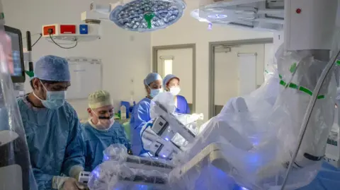 CUH Medical staff are dressed in scrubs in an operating theatre