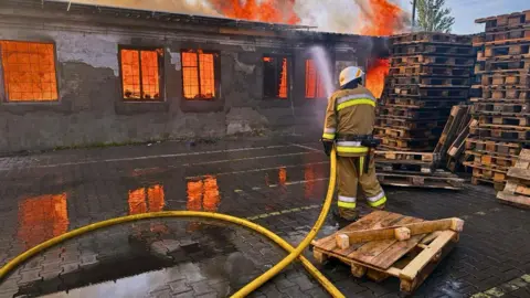 Handout picture made available by the State Emergency Service shows Ukrainian emergency services working at the site of a drone strike in the Kyiv area, Ukraine, 09 July 2025