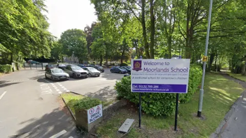 Google A white and purple sign outside a car park that reads: Welcome to Moorlands School