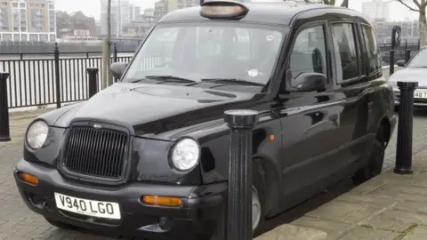 Met Police A black taxi parked up.