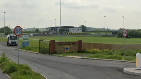 Google A view of the entrance to Melksham Rugby Club with Oakfield Stadium behind it