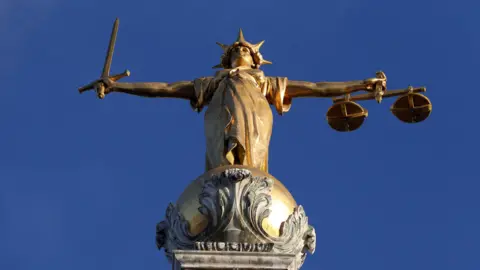 FW Pomeroy's Statue of Justice stands atop the Central Criminal Court building, Old Bailey, London. 