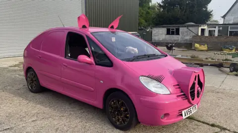 Edd Smith/BBC The Pigasso car, painted pink, including a modelled snout, eyelashes and ears