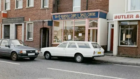 Supplied An old photo of a street with a shop called 'do it yourself curries and spices centre'