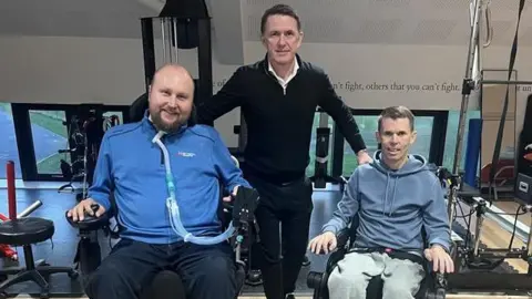 Three men inside the facilities at the Get Busy Living Centre