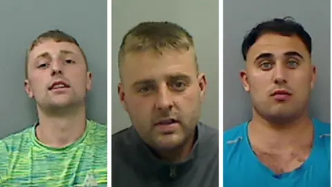 Lewis Thompson who has short blonde hair and is wearing a green t-shirt is looking at the camera in a police mugshot. Shaun Thompson who has short blonde hair and is wearing a grey zipped jacket. Jack Carlsson has dark hair and is wearing a blue t-shirt. 