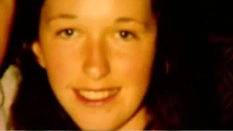 An Garda Síochána Jo Jo Dullard, close photo of her face, young woman with dark, shoulder length hair. She is looking directly into the camera.