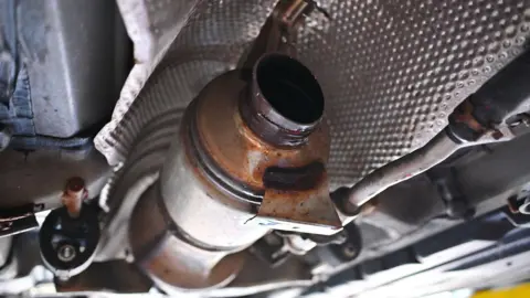 Getty Images The underside of a Toyota Prius where a catalytic converter was stolen by thieves.