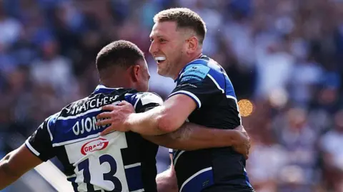 Max Ojomoh of Bath Rugby celebrates with team mate Finn Russell after scoring their second try during the Gallagher Premiership Rugby Final match between Bath Rugby and Leicester Tigers at Allianz Stadium on June 14, 2025 in London, England.