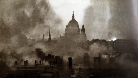 Getty Images Black and white photo of smoke surrounding the dome of St Paul's taken on 29 December 1940