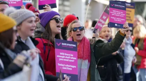Workers on the picket line outside Royal Sussex County Hospital in Brighton during a strike by nurses and ambulance staff on 6 February 2023.