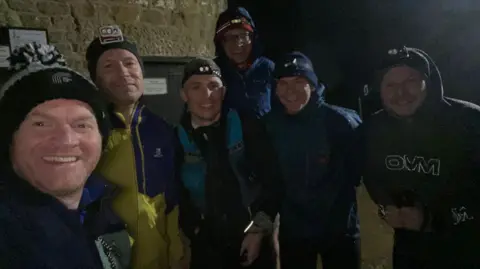 Otley Athletic Club A group of six men dressed in warm running gear and with head torches in the dark