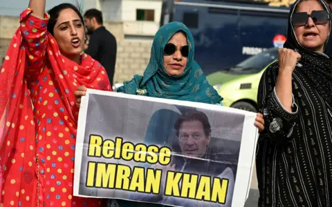 AFP via Getty Images Activists of Pakistan Tehreek-e-Insaf (PTI) party chant slogans during a protest demanding the release of jailed former Prime Minister Imran Khan, near the Adiala prison in Rawalpindi on August 5, 2025.