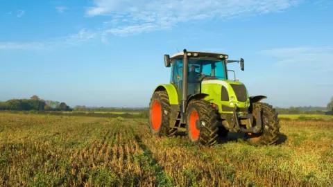 Getty Images A large green tractor in a field.