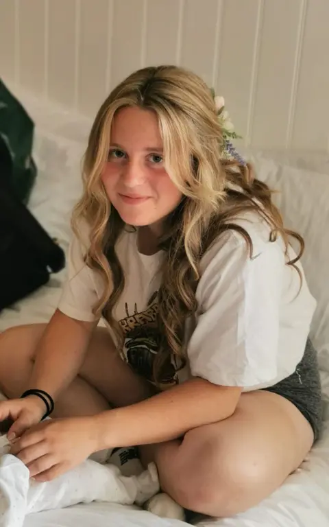 Handout Chloe pictured wearing white t-shirt, and has a bow in her blonde hair. She is smiling at the camera