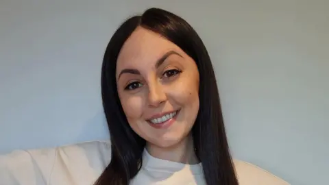 Lily Ward A woman with dark brown hair smiling into the camera