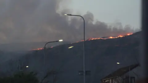 BBC Smoke bellowing from orange flames on a hill