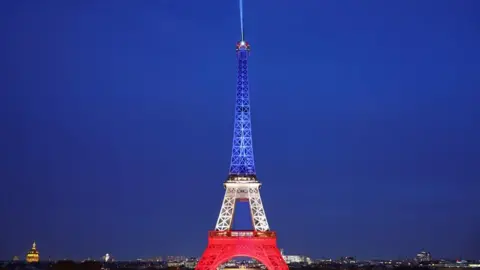 Reuters The Eiffel Tower is lit up with the blue, white and red colours of the French flag to mark the tenth anniversary of the November 13 Paris attacks