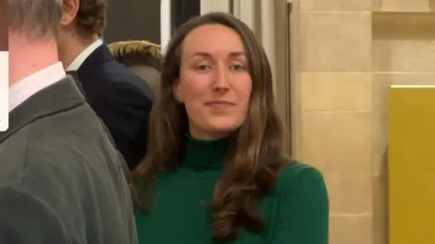 Heather Mack looking at the camera, she is wearing a green jumper