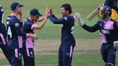 Middlesex players celebrate a wicket
