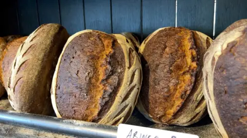 Loaves of bread on display in a bakery