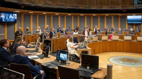 Senedd Cymru Senedd members listening to First Minister Eluned Morgan speak in the Welsh Parliament