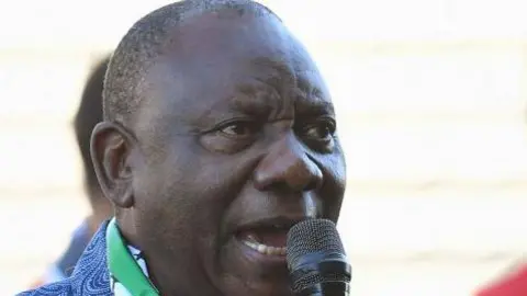 AFP President CYril Ramaphosa animatedly speaking into a microphone.