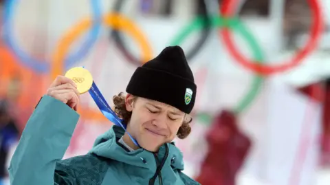 Lucas Pinheiro Braathen holds up his Olympic gold medal