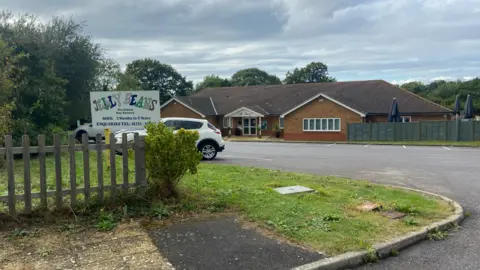 JOSIE HANNETT Jelly Beans Day Nursery with a car in the car park