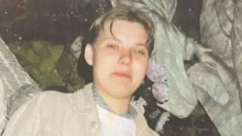 Image of Izabela who has short hair and is wearing a beige jacket.
