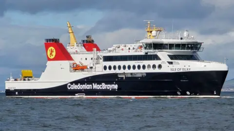 A large black and white ship with red funnels, with Isle of Islay written on the bow