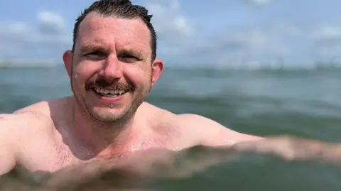 Will Flockton/BBC Will Flockton topless in the water looking at the camera