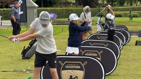 Young golfers practising their swings