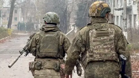 An image shared by the Russian Defence Ministry press-service which claims to show two Russian servicemen in military garb checking streets of Krasnoarmeysk (Pokrovsk) in the Donetsk region in Ukraine. 