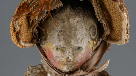 A painted face of a doll 