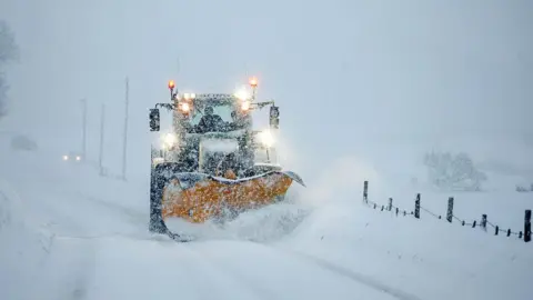 Getty Images A snowplough clears the A944 in Aberdeenshire on Tuesday, heavily covered ins now with low visibility.