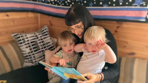 NATHAN STANDLEY/BBC Nursery teacher with two kids