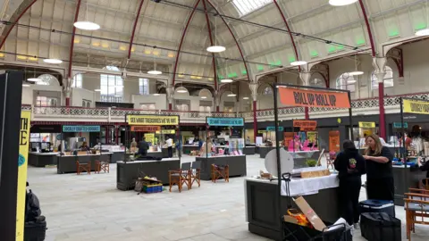 A view inside the ground floor of the Derby Market Hall with stalls dotted around the site