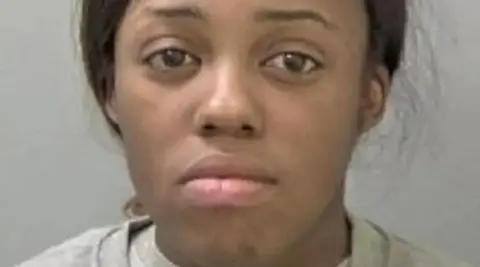 West Mercia Police A mug shot of a woman with dark hair tied back and wearing a light grey top